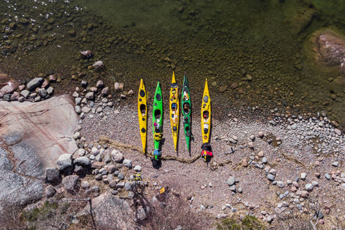 Drone view of four kayaks on the shoreline