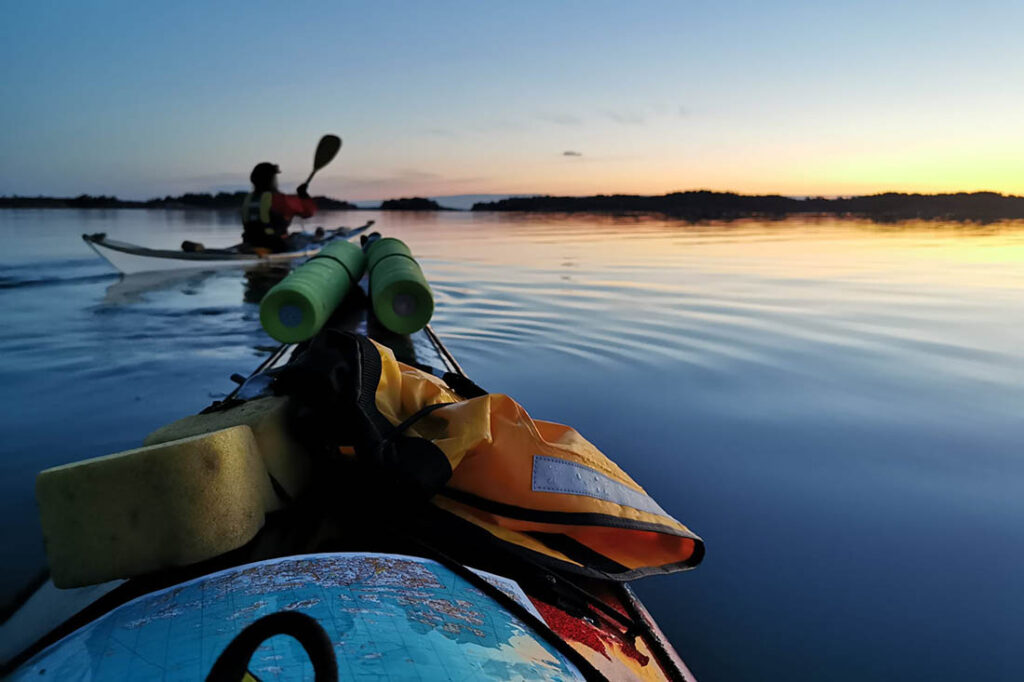Two kayakers and a beautiful sunset in the archipelago sea